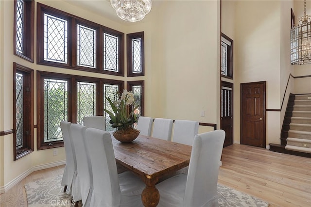 6137 Paseo La Vis, Woodland Hills, CA 91367 - dining room with a high ceiling, stairs, a chandelier, plenty of natural light, and light wood-type flooring
