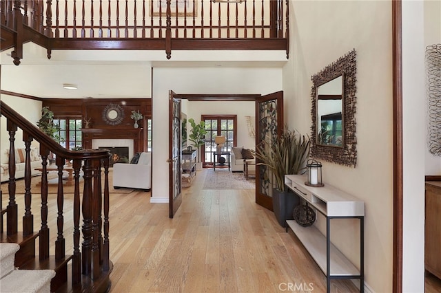 6137 Paseo La Vis, Woodland Hills, CA 91367 - foyer entrance with stairs, a towering ceiling, wood finished floors, and a fireplace