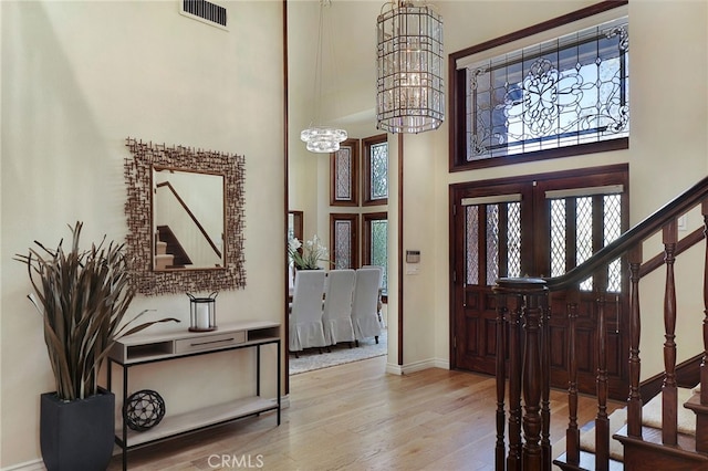 6137 Paseo La Vis, Woodland Hills, CA 91367 - entryway with a high ceiling, wood-type flooring, a chandelier, and stairway