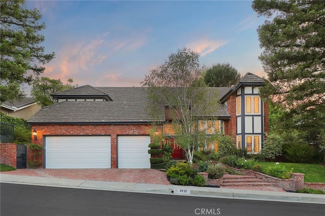 6137 Paseo La Vis, Woodland Hills, CA 91367 - view of front of property with driveway, brick siding, an attached garage, and a tile roof