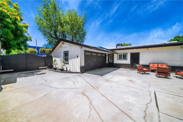 780 S Briargate Ln, Covina, CA 91723 - back of house featuring board and batten siding, an attached garage, a gate, and driveway
