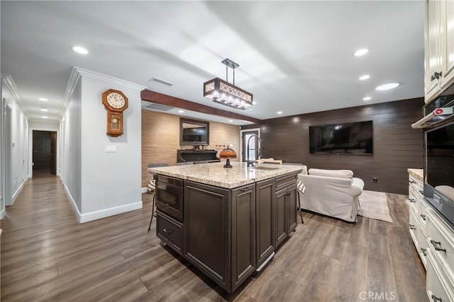 780 S Briargate Ln, Covina, CA 91723 - kitchen featuring open floor plan, built in microwave, dark brown cabinets, stainless steel oven, and ornamental molding