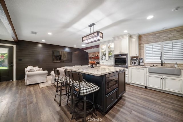 780 S Briargate Ln, Covina, CA 91723 - kitchen featuring appliances with stainless steel finishes, a breakfast bar, white cabinets, a kitchen island, and recessed lighting