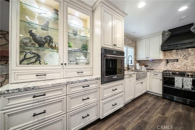 780 S Briargate Ln, Covina, CA 91723 - kitchen featuring stainless steel appliances, custom range hood, dark wood-style flooring, light stone countertops, and white cabinets