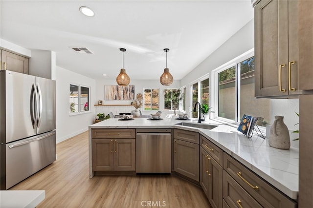 41442 Avenida De La Reina, Temecula, CA 92592 - kitchen with appliances with stainless steel finishes, tasteful backsplash, light wood finished floors, light stone countertops, and recessed lighting