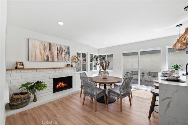 41442 Avenida De La Reina, Temecula, CA 92592 - dining room featuring plenty of natural light, light wood-type flooring, a brick fireplace, and recessed lighting