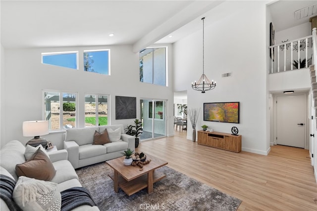 41442 Avenida De La Reina, Temecula, CA 92592 - living area with a chandelier, a towering ceiling, light wood-type flooring, and recessed lighting