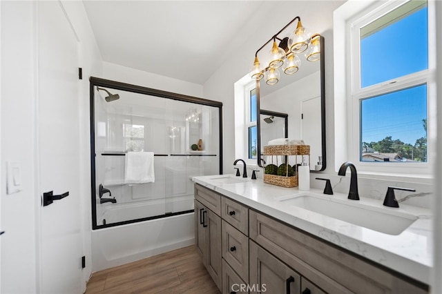41442 Avenida De La Reina, Temecula, CA 92592 - full bath with healthy amount of natural light, double vanity, bath / shower combo with glass door, and wood finished floors