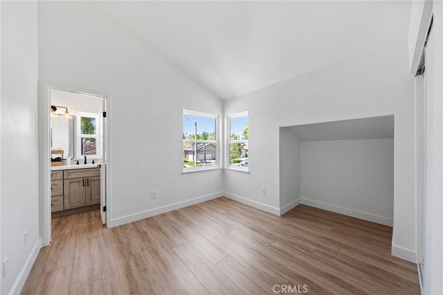 41442 Avenida De La Reina, Temecula, CA 92592 - unfurnished bedroom with lofted ceiling, multiple windows, light wood finished floors, and ensuite bath