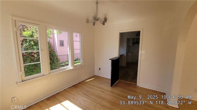 805 S Crane Ave, Compton, CA 90221 - unfurnished dining area featuring plenty of natural light, wood finished floors, and a chandelier