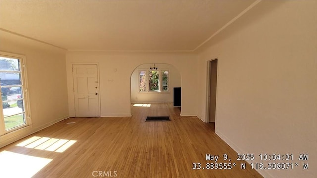 805 S Crane Ave, Compton, CA 90221 - unfurnished living room featuring arched walkways and wood finished floors