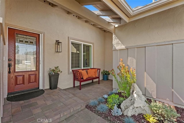 2168 N Agate St, Orange, CA 92867 - view of exterior entry with stucco siding and a patio