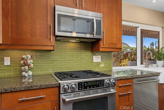 2168 N Agate St, Orange, CA 92867 - kitchen featuring stainless steel appliances, tasteful backsplash, dark stone countertops, and brown cabinets