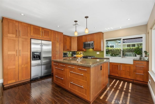 2168 N Agate St, Orange, CA 92867 - kitchen with appliances with stainless steel finishes, dark wood-style flooring, brown cabinets, and recessed lighting