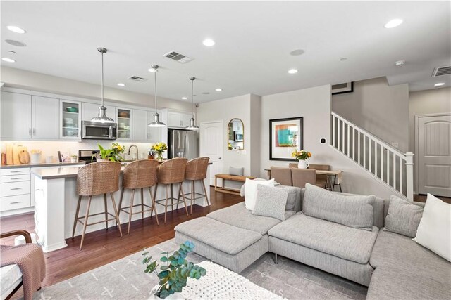 22088 Barrington Way, Saugus, CA 91350 - living room with dark wood-type flooring, stairs, and recessed lighting