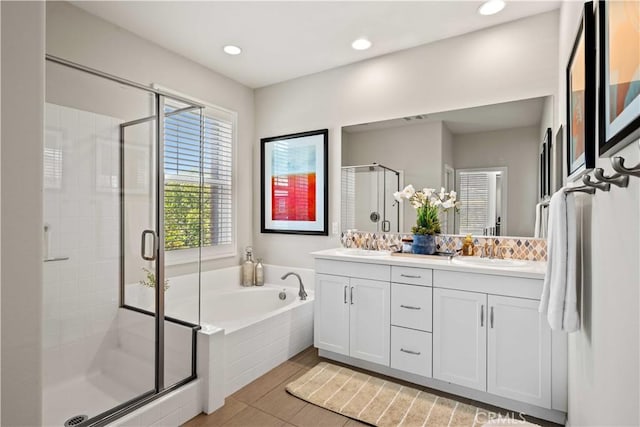22088 Barrington Way, Saugus, CA 91350 - bathroom featuring double vanity, a stall shower, a garden tub, wood finished floors, and recessed lighting