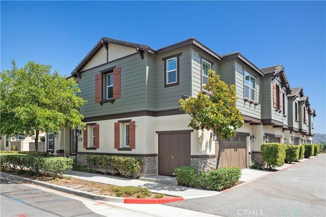 22088 Barrington Way, Saugus, CA 91350 - townhome / multi-family property with an attached garage and stone siding