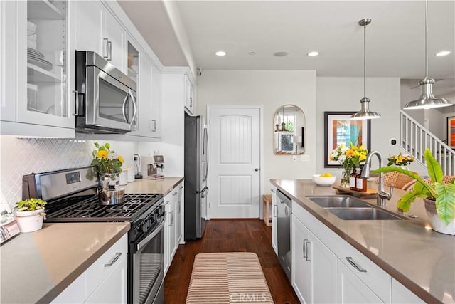 22088 Barrington Way, Saugus, CA 91350 - kitchen featuring stainless steel appliances, dark wood-type flooring, glass insert cabinets, decorative backsplash, and decorative light fixtures