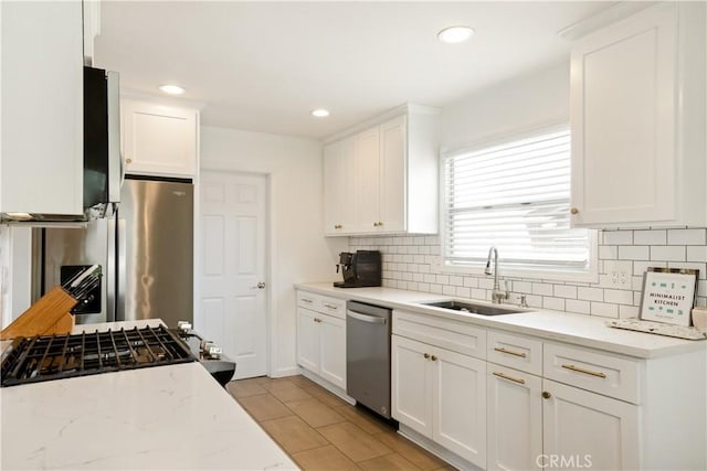 817 Caballo Ave, Glendora, CA 91740 - kitchen featuring appliances with stainless steel finishes, decorative backsplash, white cabinets, light stone counters, and recessed lighting
