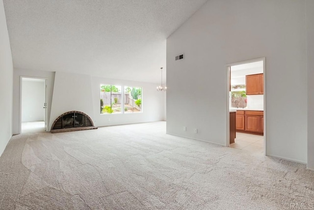 3694 Branch Ct, Oceanside, CA 92058 - unfurnished living room with light colored carpet, a fireplace with raised hearth, a chandelier, and high vaulted ceiling