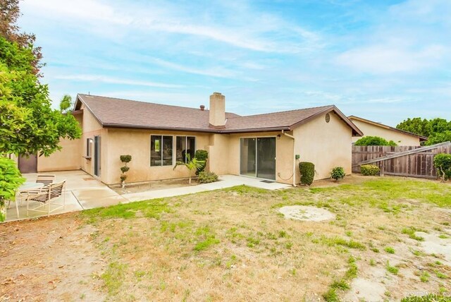 3694 Branch Ct, Oceanside, CA 92058 - rear view of house featuring a patio area, a chimney, and stucco siding