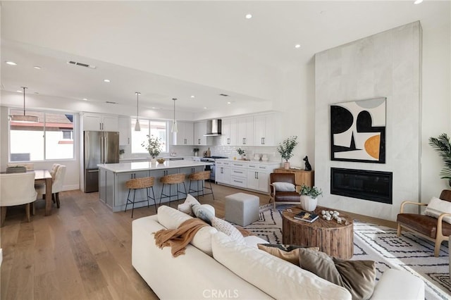 1700 Perkins Ln, Redondo Beach, CA 90278 - living room featuring light wood finished floors, recessed lighting, and a fireplace