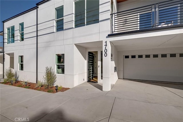 1700 Perkins Ln, Redondo Beach, CA 90278 - view of home's exterior featuring a balcony, stucco siding, and a garage