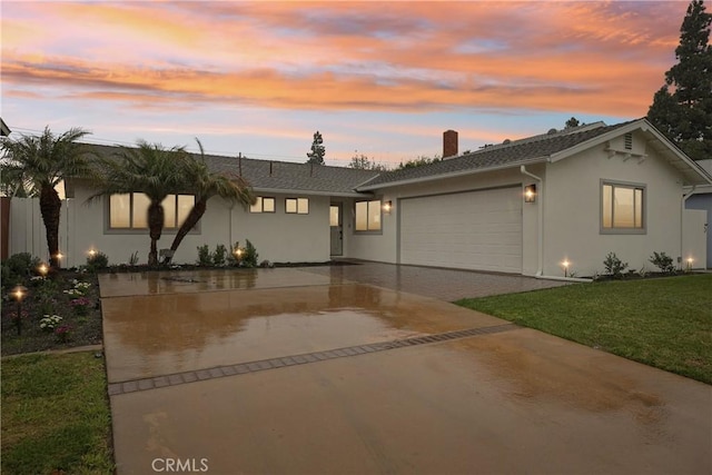 1147 Charleston St, Costa Mesa, CA 92626 - single story home with a garage, driveway, a chimney, a yard, and stucco siding