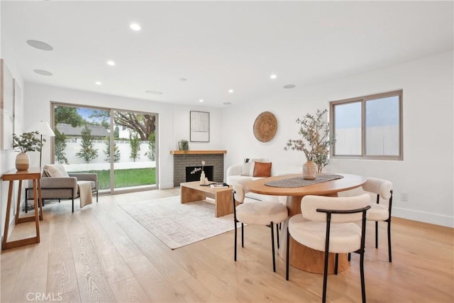 1147 Charleston St, Costa Mesa, CA 92626 - dining room featuring light wood finished floors, recessed lighting, and a fireplace
