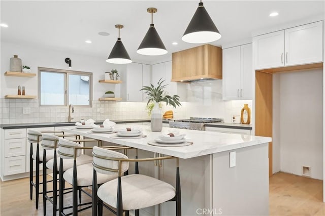 1147 Charleston St, Costa Mesa, CA 92626 - kitchen featuring open shelves, light wood-style flooring, backsplash, and recessed lighting