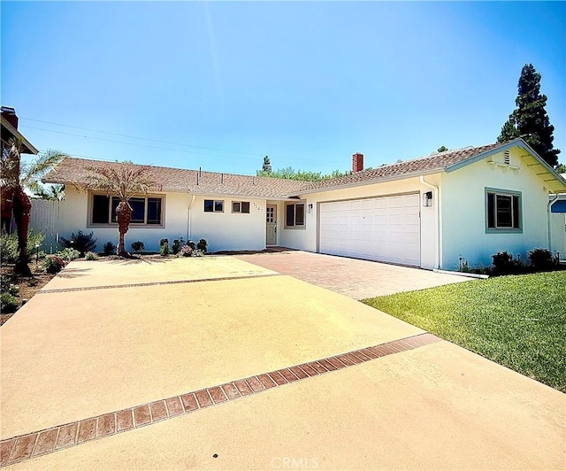 1147 Charleston St, Costa Mesa, CA 92626 - ranch-style house with a chimney, a garage, driveway, and stucco siding