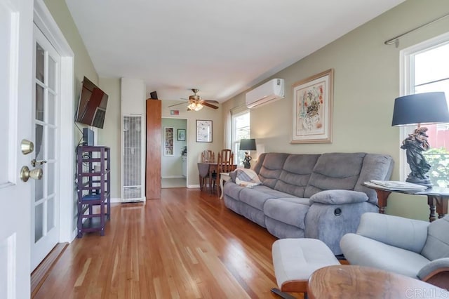 730 S 31st St, San Diego, CA 92113 - living room featuring a wall mounted AC, a heating unit, light wood-type flooring, and ceiling fan