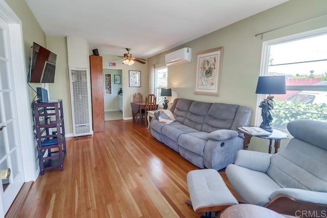 730 S 31st St, San Diego, CA 92113 - living room featuring a heating unit, an AC wall unit, light wood finished floors, and healthy amount of natural light