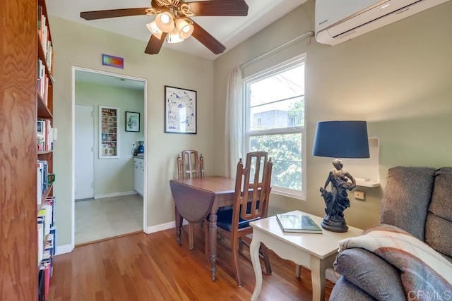 730 S 31st St, San Diego, CA 92113 - dining room featuring a wall unit AC, a ceiling fan, and wood finished floors