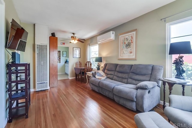 730 S 31st St, San Diego, CA 92113 - living area with an AC wall unit, a heating unit, wood finished floors, and ceiling fan