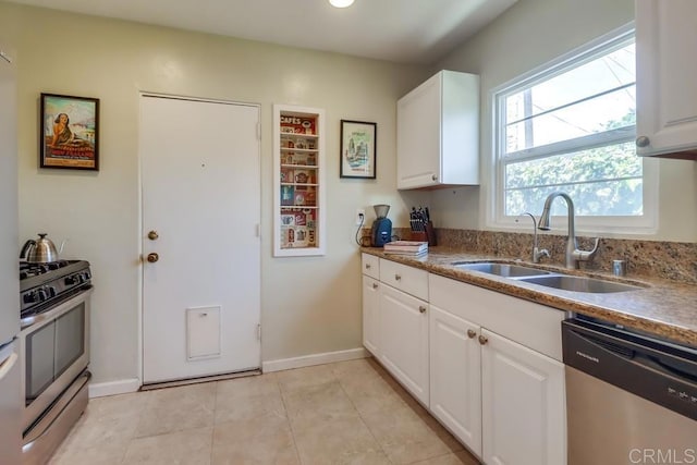 730 S 31st St, San Diego, CA 92113 - kitchen with stainless steel appliances, white cabinetry, and light tile patterned floors