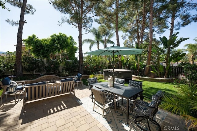 2350 Claudia St, Corona, CA 92882 - fenced backyard featuring a patio, a hot tub, outdoor dining space, and an outdoor hangout area