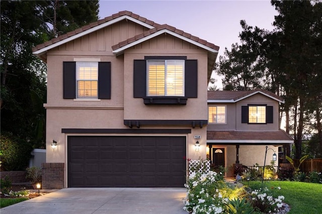 2350 Claudia St, Corona, CA 92882 - view of front of house with concrete driveway, a garage, a porch, and a tile roof