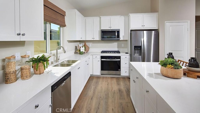 457 Wildrose Cir, San Jacinto, CA 92582 - kitchen with stainless steel appliances, wood finished floors, light countertops, and white cabinetry