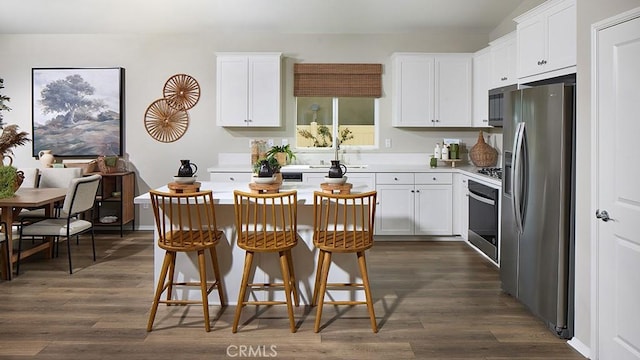 457 Wildrose Cir, San Jacinto, CA 92582 - kitchen featuring appliances with stainless steel finishes, dark wood-style floors, light countertops, and white cabinetry