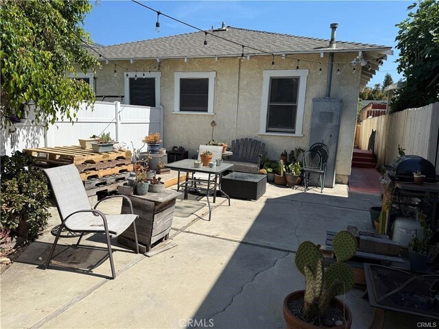 782 W 14th St, San Pedro, CA 90731 - rear view of property featuring stucco siding, a patio area, and roof with shingles