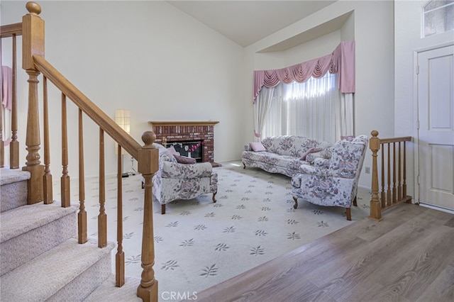 6721 Silver Oak Pl, Riverside, CA 92506 - living room featuring vaulted ceiling, wood finished floors, and a brick fireplace