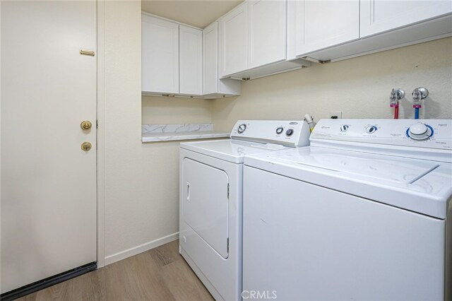 6721 Silver Oak Pl, Riverside, CA 92506 - washroom with washer and clothes dryer, light wood-type flooring, and cabinet space