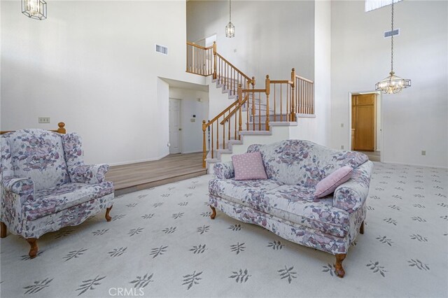 6721 Silver Oak Pl, Riverside, CA 92506 - living area featuring a high ceiling, carpet floors, stairs, and a chandelier