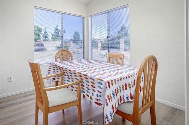 6721 Silver Oak Pl, Riverside, CA 92506 - dining area with plenty of natural light, wood finished floors, and a textured wall