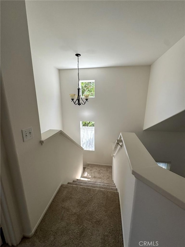 9 Greenwich Ct, Aliso Viejo, CA 92656 - staircase featuring a chandelier and carpet flooring