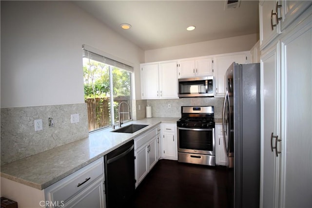 9 Greenwich Ct, Aliso Viejo, CA 92656 - kitchen with stainless steel appliances, white cabinetry, tasteful backsplash, recessed lighting, and light stone countertops