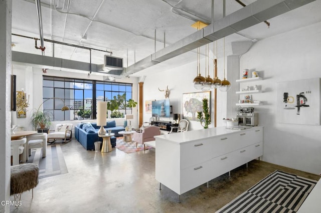 315 E 8th St Unit 301, Los Angeles, CA 90014 - kitchen featuring a peninsula, open floor plan, white cabinetry, concrete flooring, and open shelves