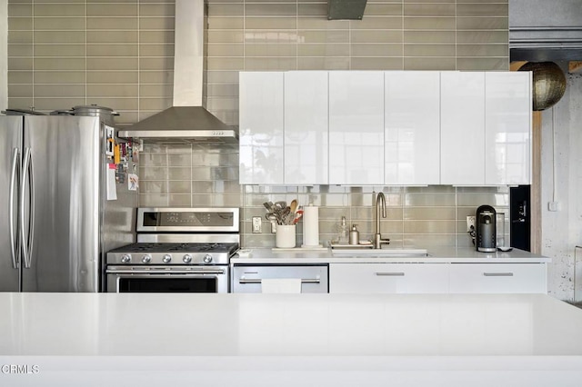 315 E 8th St Unit 301, Los Angeles, CA 90014 - kitchen with appliances with stainless steel finishes, wall chimney exhaust hood, backsplash, modern cabinets, and white cabinets