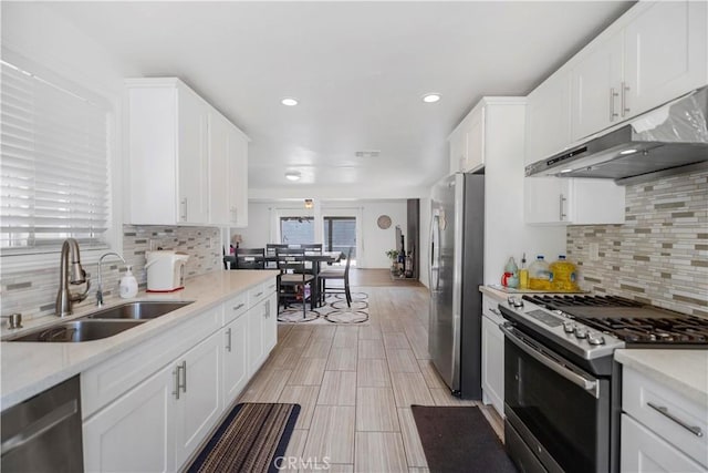1322 W 6th St, Ontario, CA 91762 - kitchen with appliances with stainless steel finishes, under cabinet range hood, white cabinetry, decorative backsplash, and recessed lighting